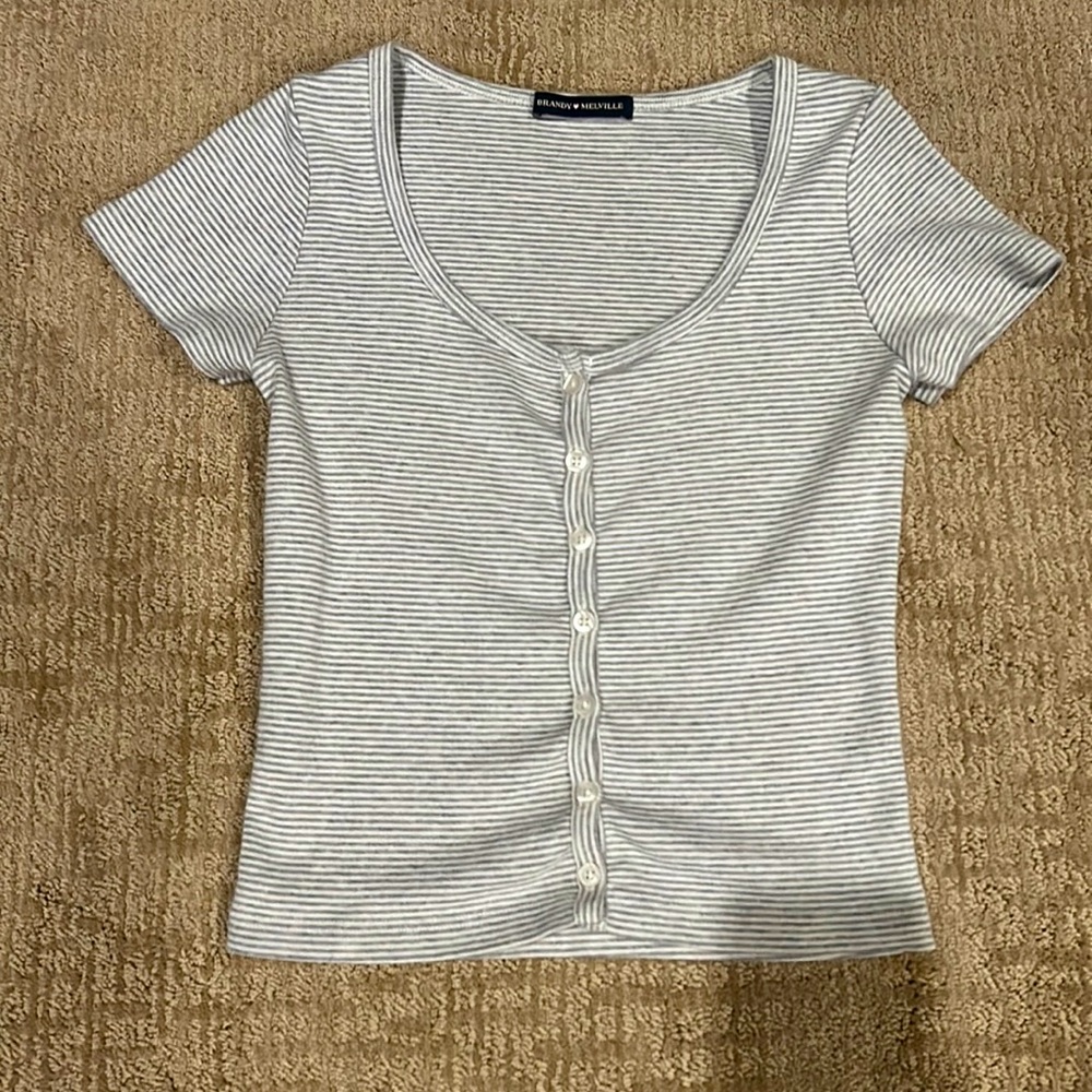 This is a shirt from brandy Melville it is striped with light blue/ grey & white